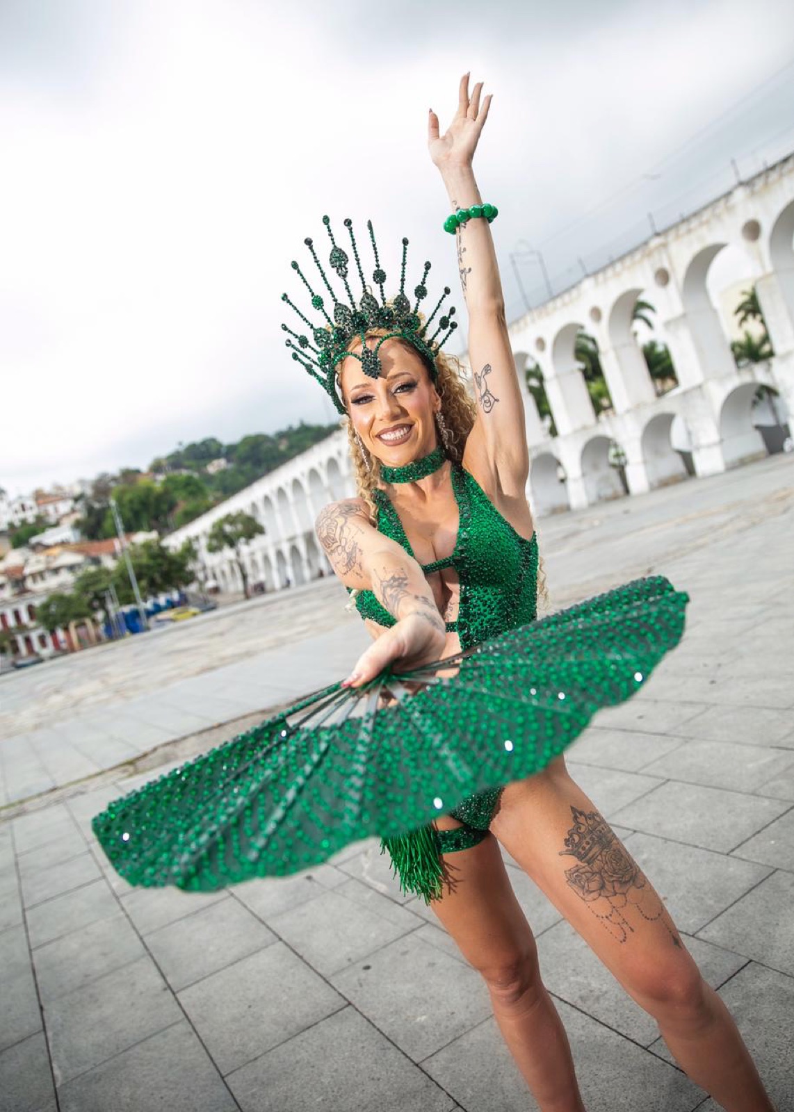 Anna with a green feathered fan at the Lapa Arches in Rio de Janeiro