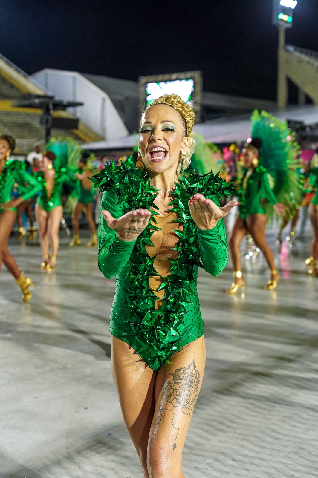 Anna performing in a green sequined costume at the Sambadrome