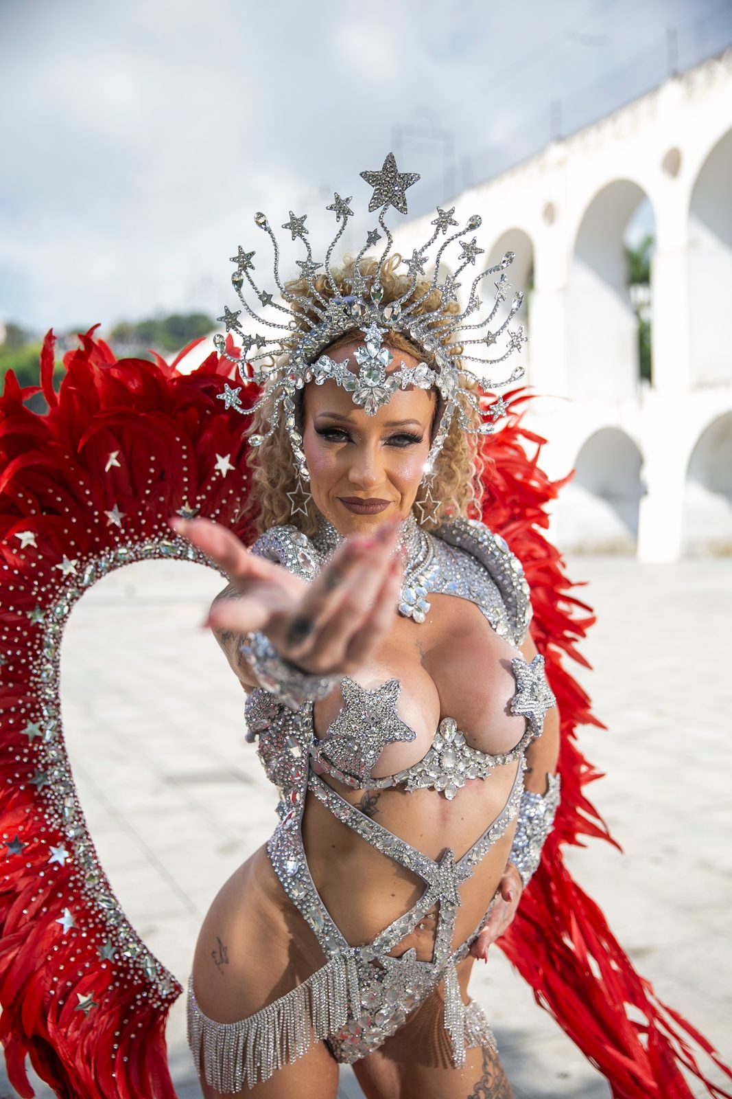 Anna in a crystal star crown and red feathered wings